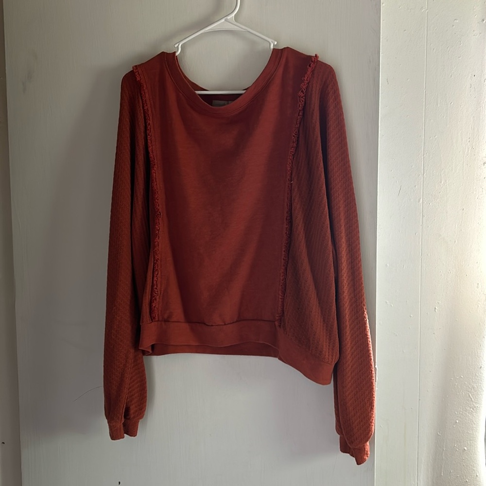 Burnt orange sweater.